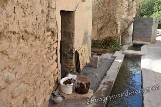 Working falaj (water channel system) at Al Manah