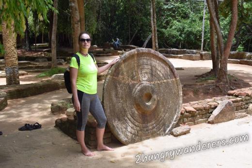 Huge stone parasol, fallen from one of the stupas